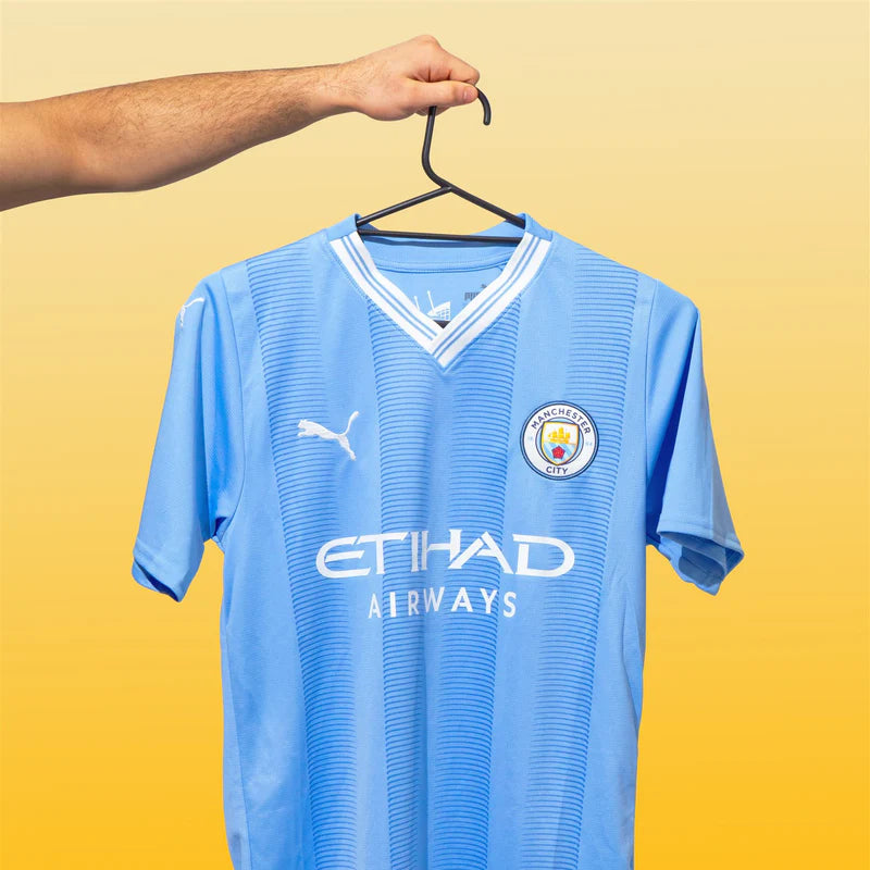 Manchester City jersey on a yellow background